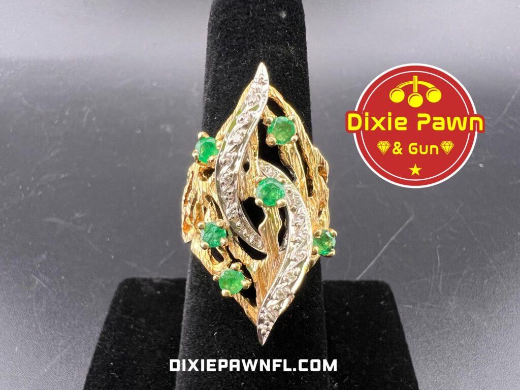 Unique gold and emeral ring available for layaway at Dixie Pawn in Hollywood, FL. 