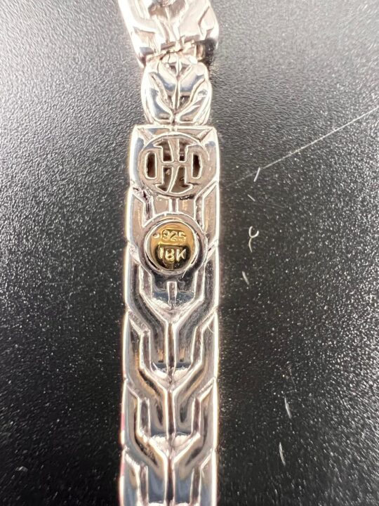 John Hardy Earring Back – Sterling Silver & 18K Gold Hallmarks at Dixie Pawn - Dixie Pawn & Jewelry Back of a John Hardy sterling silver and 18K gold earring showing .925 and 18K hallmarks with signature artisan detailing