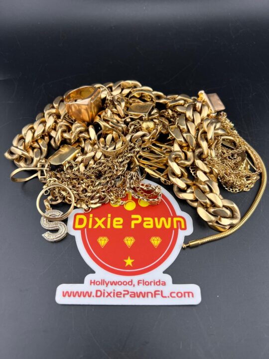 A pile of gold jewelry including chains and rings next to the Dixie Pawn logo, located in Hollywood, Florida.