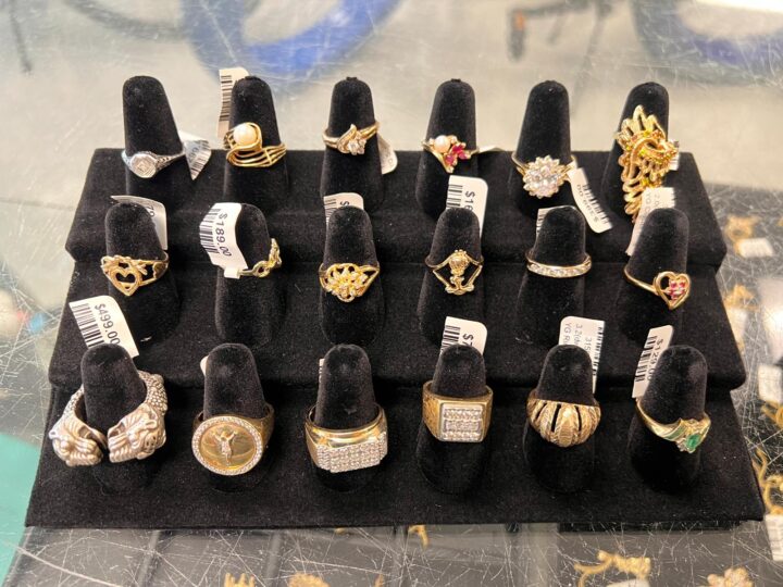 A display of gold and diamond rings with various designs, including heart-shaped, gemstone, and vintage styles, available for sale at Dixie Pawn in Hollywood, FL.