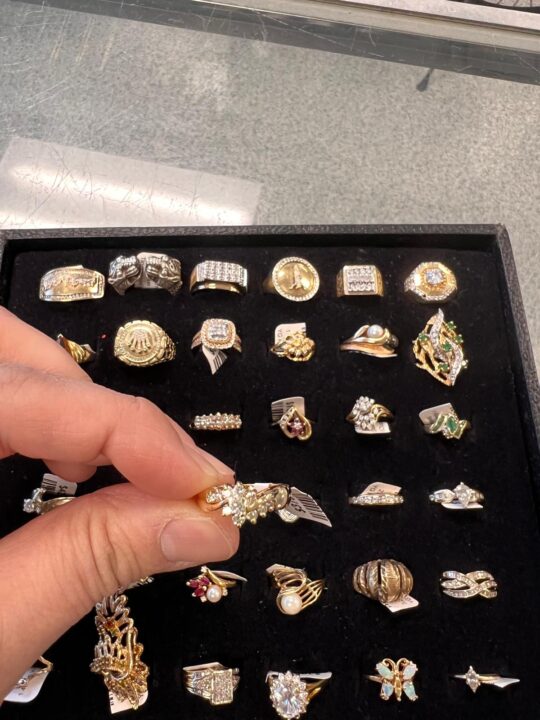 A display of assorted gold and diamond rings available at Dixie Pawn in Hollywood, Florida