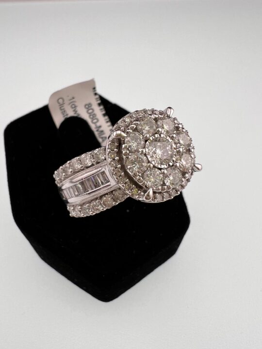 This exquisite 10K white gold estate ring is adorned with a breathtaking array of diamonds in a halo cluster design, complemented by baguette and round-cut accents. A true statement piece, this ring is perfect for those seeking timeless elegance and exceptional craftsmanship. Whether you're looking to pawn, sell, or simply admire, Dixie Pawn evaluates pieces like this for their intrinsic and market value, ensuring a fair and competitive offer. Visit us in Hollywood, FL, for a personalized appraisal!