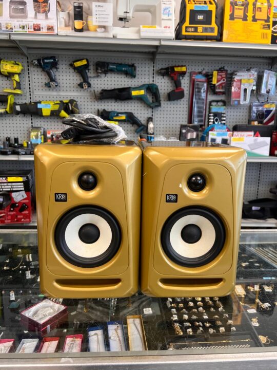 A pair of used KRK ROKIT 5 powered studio monitors, featuring the iconic yellow speaker cone and suitable for recording and mixing applications.