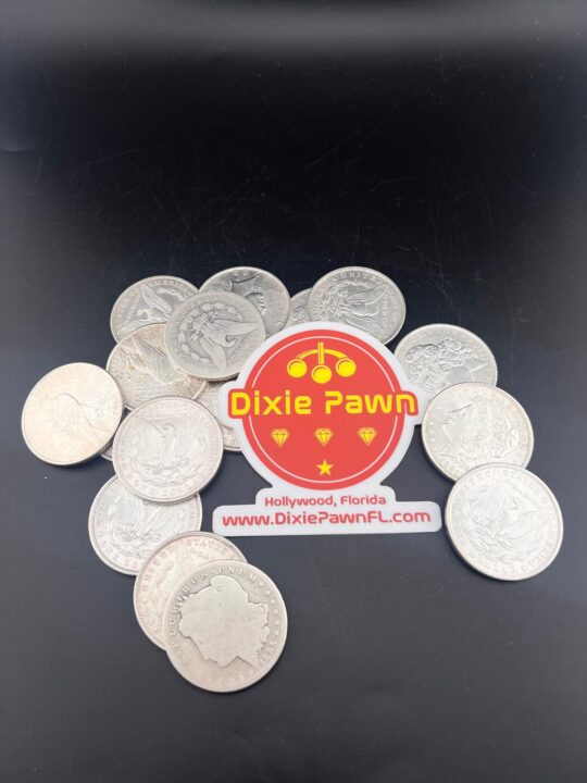 Pile of Silver Liberty coins (1922-1969) with Dixie Pawn logo, showcasing rare coin appraisals and sales in Hollywood, FL.