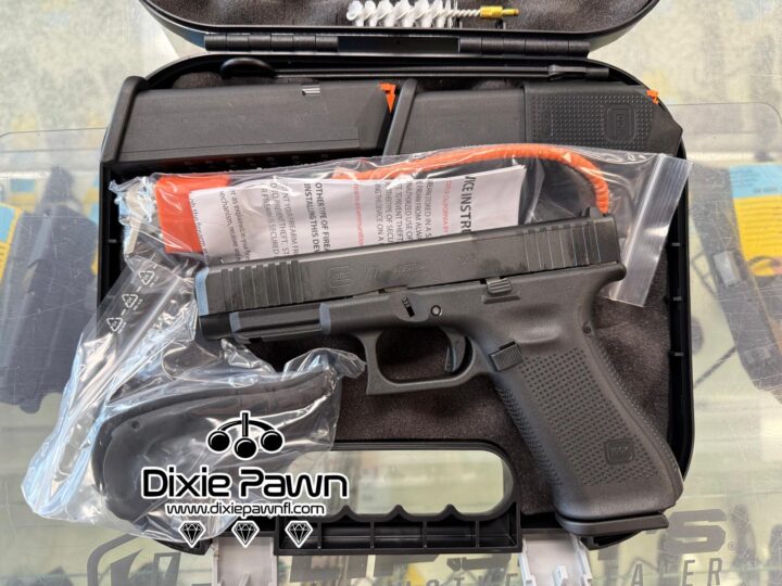 Factory-new Glock 47 9x19mm semi-automatic pistol in its factory case — two mags, cable lock and spare backstraps included. Photo shows slide, controls, and accessories; available at Dixie Pawn.